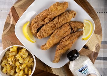 Golden-brown, crispy Southern Fried Fish served with lemon wedges and tartar sauce