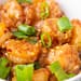 Plump shrimp bathed in a glossy honey garlic sauce, topped with crisp green onions and fiery red pepper flakes.
