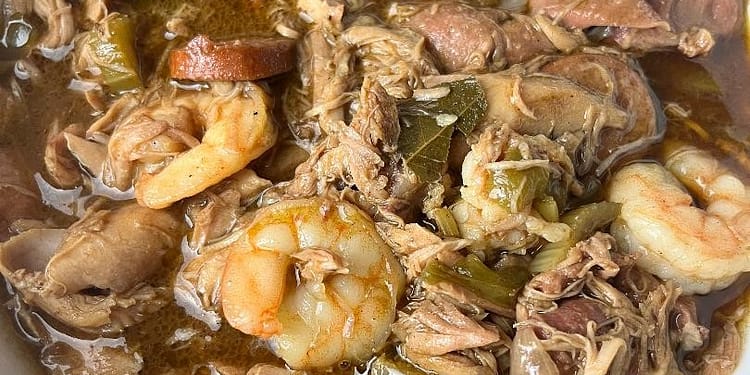 A steaming bowl of authentic Southern Gumbo, loaded with chicken, sausage, and shrimp