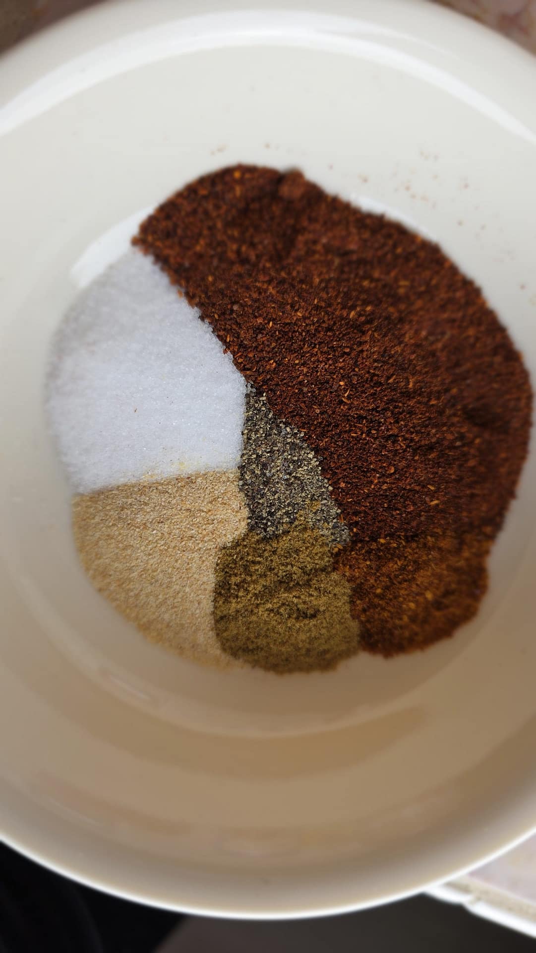 Spices and aromatics laid out for chili