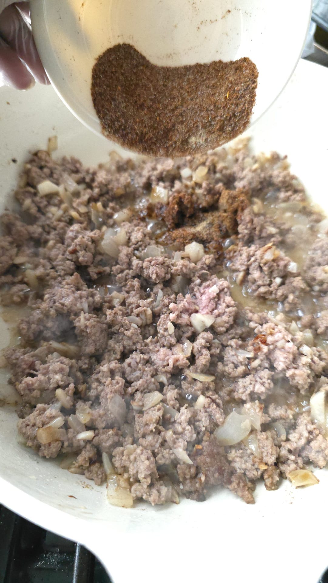 Ground beef seasoned with chili spices in skillet