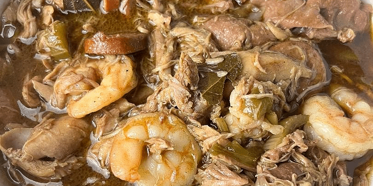 A steaming bowl of authentic Southern Gumbo, loaded with chicken, sausage, and shrimp