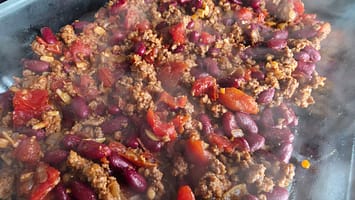 Close-up of ground beef chili with red beans and tomatoes for Chili Cornbread Casserole.