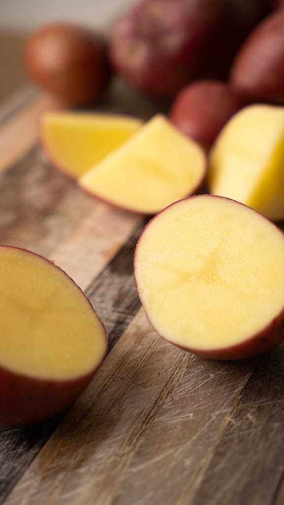 Sliced red potatoes with skins on, ready to be cooked for a chunky garlic mashed potato recipe