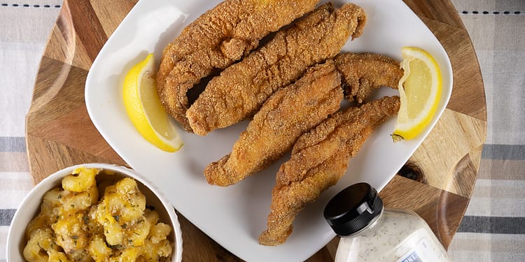 Golden-brown, crispy Southern Fried Fish served with lemon wedges and tartar sauce